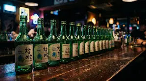 Row of empty soju bottles lined up at a Korean drinking session